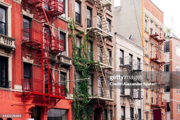 apartment buildings facade in new york city, usa - lower east side stockfoto's en -beelden