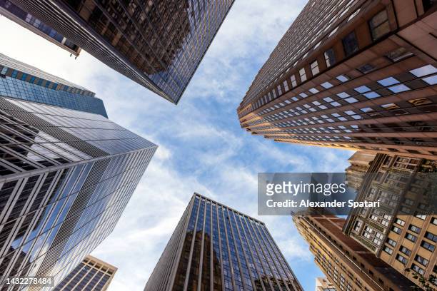 low angle view of skyscrapers in manhattan financial district, new york city, usa - wall street lower manhattan imagens e fotografias de stock