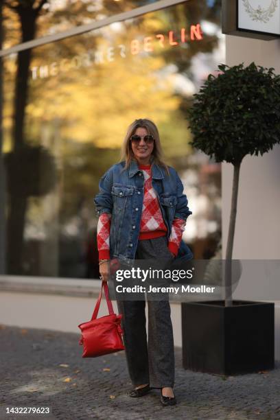 Yasmin von Schlieffen-Nannen wearing black Celine ballerinas, blue Acne Studios jeans jacket, red Essential Antwerp sweater, red Loewe bag, Isabel...