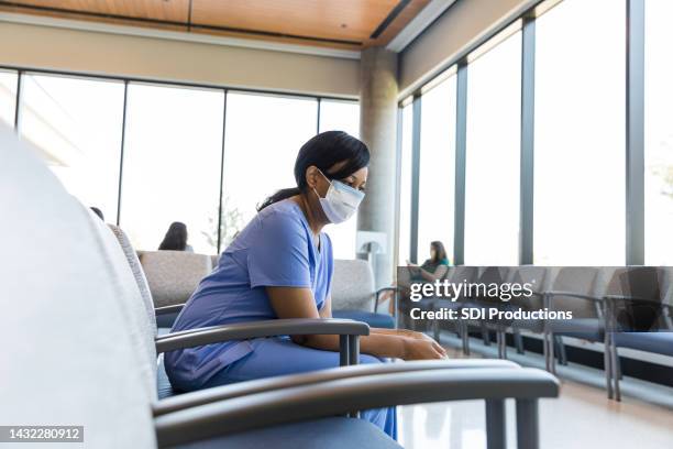 emotionally stressed and exhausted, female nurse takes break - nurse meditating stock pictures, royalty-free photos & images