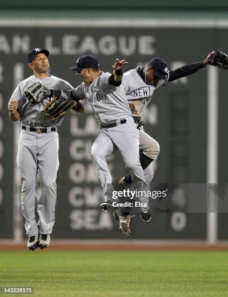 Nick Swisher, Curtis Granderson and Raul Ibanez of the New York Yankees celebrate the win over the Boston Red Sox on April 21, 2012 at Fenway Park in...