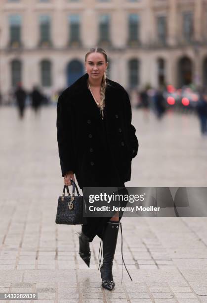 Nina Suess is seen wearing gold earrings, gold pendant necklaces, black long slit dress, black fluffy wool Saint Laurent jacket, black leather Lady...