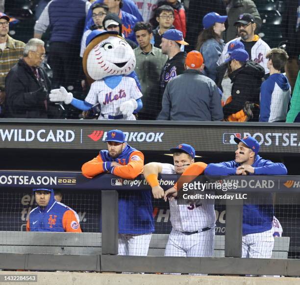 New York Mets players in the dugout at Citi Field in Flushing, New York, dejected after losing to the San Diego Padres and being eliminated from the...