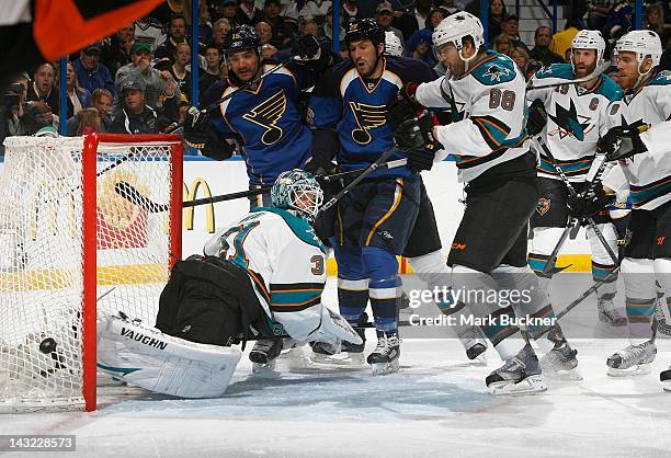 Antti Niemi and Brent Burns of the San Jose Sharks defend the net against Jamie Langenbrunner and B.J. Crombeen of the St. Louis Blues in Game Five...