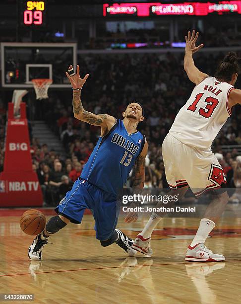 Delonte West of the Dallas Mavericks looses the ball after running into Jaokim Noah of the Chicago Bulls at the United Center on April 21, 2012 in...