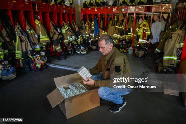 Firefighter opens a box full of iodine tablets inside the Firefighters headquarters, one of the distribution points for the pills, on October 10,...