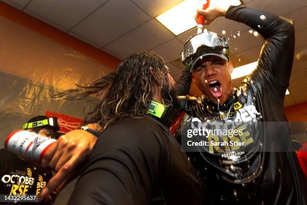 Jorge Alfaro and Juan Soto of the San Diego Padres celebrate in the locker room after defeating the New York Mets in game three to win the National...