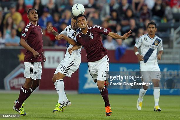 Juninho of the Los Angeles Galaxy and Kamani Hill of the Colorado Rapids battle for a head ball at Dick's Sporting Goods Park on April 21, 2012 in...