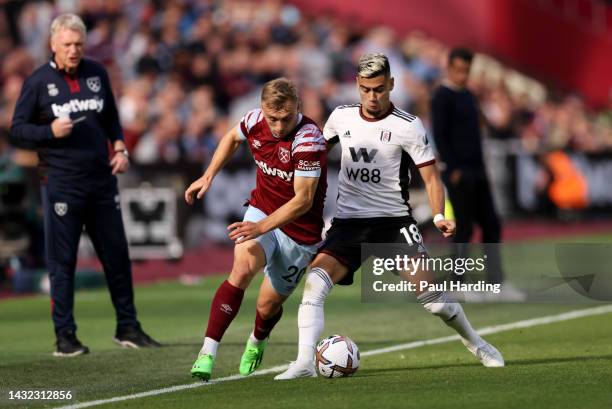 Jarrod Bowen of West Ham United and Andreas Pereira of Fulham battle for the ball during the Premier League match between West Ham United and Fulham...