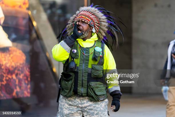 Man wearing an American Indian headdress attends the Columbus Day Parade in Midtown on October 10, 2022 in New York City.