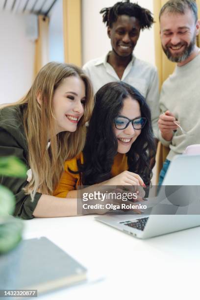 techno geeks and technophiles joy new laptop. colleagues having fun and looking at laptop in office. - name patch stock pictures, royalty-free photos & images