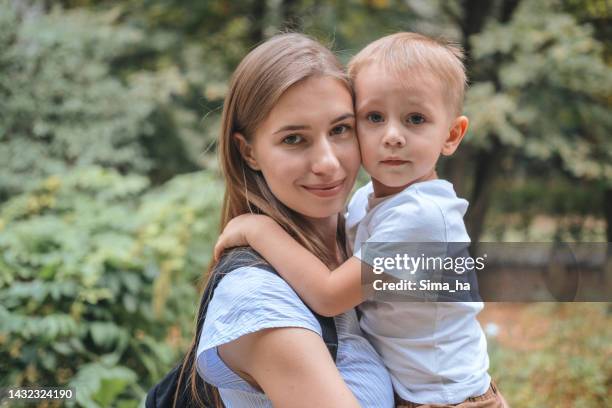 portrait of a young mother and son in the park - park ha stock pictures, royalty-free photos & images