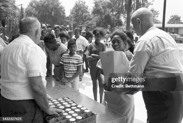 The Salvation Army passes out food at 104th and Compton in the Watts area of Los Angeles. The rioting in Watts left some in need as the district...