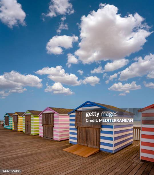 hastings pier colorful striped huts resort, east sussex england uk - portsmouth-beach stock pictures, royalty-free photos & images