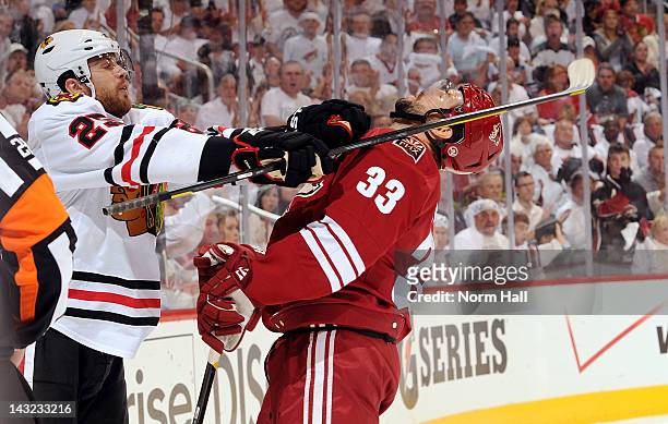 Adrian Aucoin of the Phoenix Coyotes takes a punch from Viktor Stalberg of the Chicago Blackhawks in Game Five of the Western Conference...