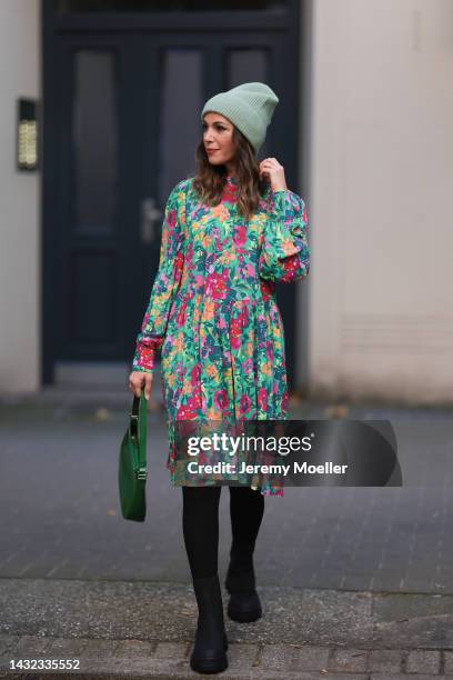 Anna Wolfers wearing a mint-colored knitted hat, colorful long dress, black tights, black boots and a green handbag on October 06, 2022 in Hamburg,...