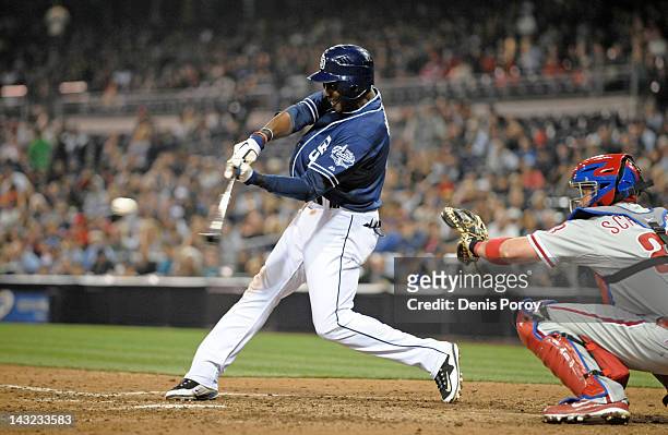 Orlando Hudson of the San Diego Padres hits an RBI triple during the eighth inning of a baseball game against the Philadelphia Phillies at Petco Park...