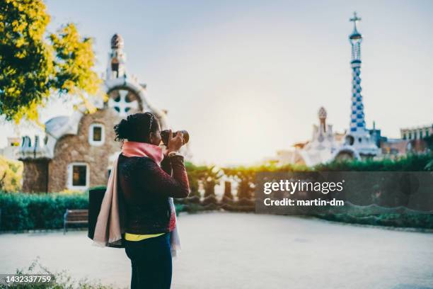 mixed race traveler exploring europe with camera - winter barcelona stock pictures, royalty-free photos & images