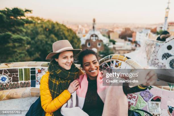 friends taking selfie at park guell,barcelona - winter barcelona stock pictures, royalty-free photos & images