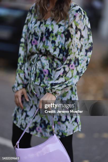 Anna Wolfers wearing a colorful dress, black tights, black boots and a purple handbag on October 06, 2022 in Hamburg, Germany.