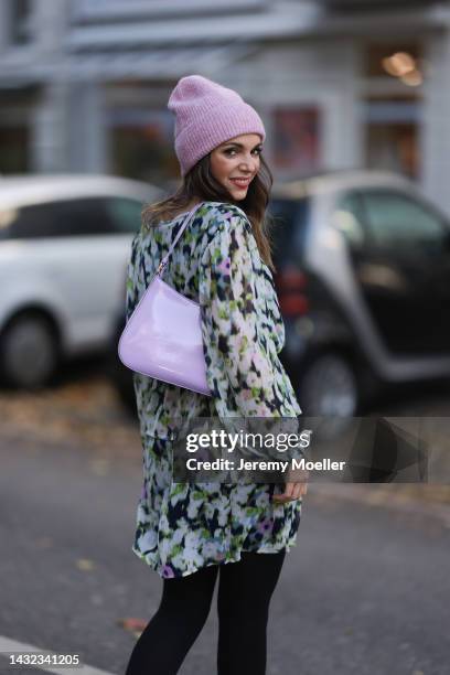 Anna Wolfers wearing a a purple knitted hat, colorful dress, black tights and a purple handbag on October 06, 2022 in Hamburg, Germany.