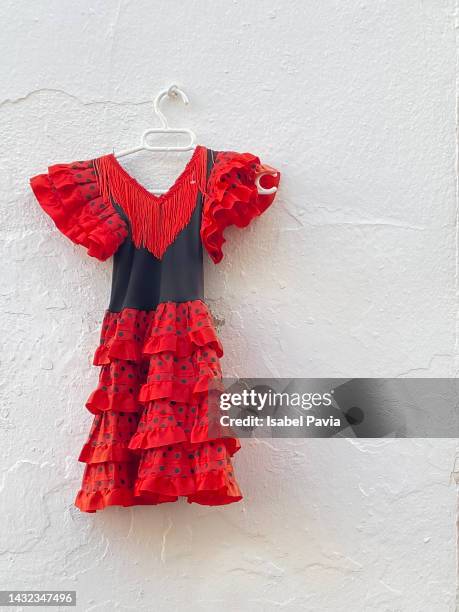 flamenco dress hanging on wall - spanish culture stock-fotos und bilder