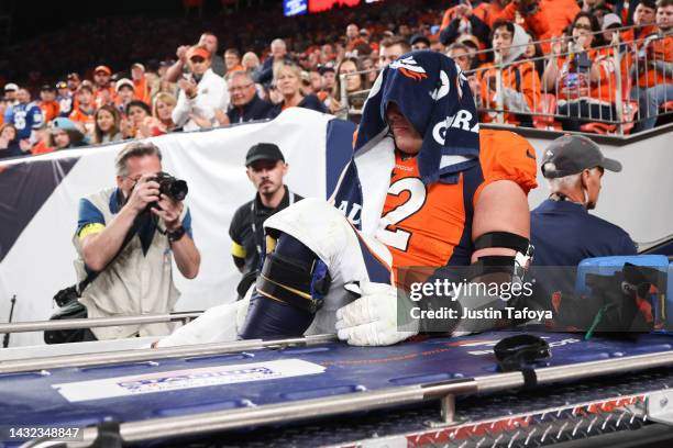 Garett Bolles of the Denver Broncos is carted off the field during a game against the Indianapolis Coltsat Empower Field At Mile High on October 6,...