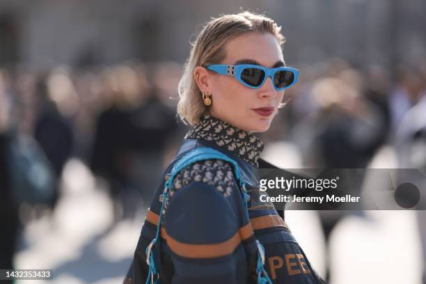 Fashion week guest seen wearing a blue Balenciaga le cagole bag and shades by Balenciaga, outside Louis Vuitton during Paris Fashion Week on October...