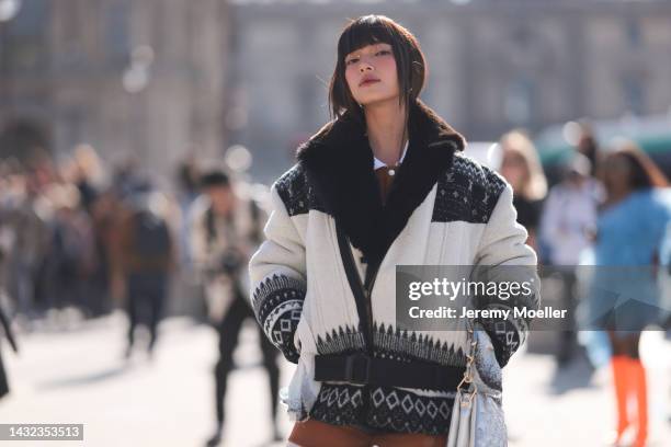 Fashion week guest seen wearing a total Louis Vuitton look, outside Louis Vuitton during Paris Fashion Week on October 04, 2022 in Paris, France.