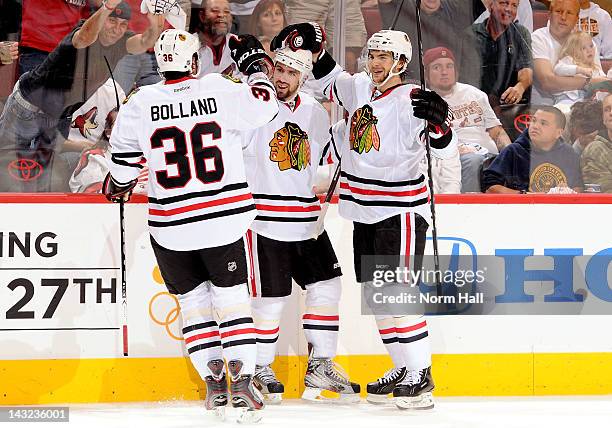 Nick Leddy of the Chicago Blackhawks celebrates with teammates Dave Bolland and Michael Frolik after scoring against the Phoenix Coyotes in Game Five...