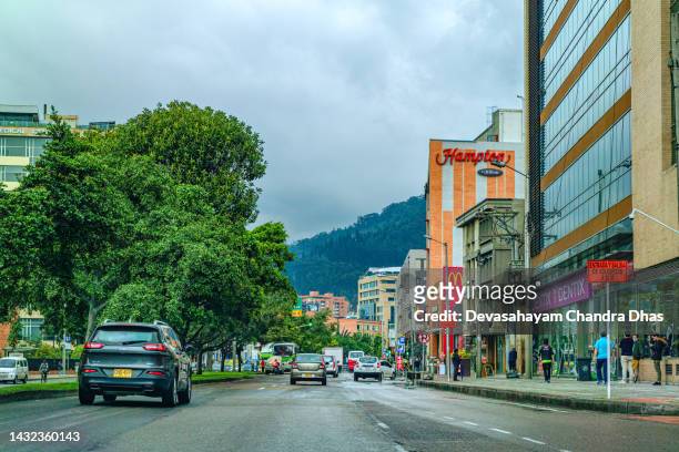 bogotá, colombia - the drivers point of view on the northbound carriageway of carrera septima in the bario de usaquén on an overcast day. - capital hilton stock pictures, royalty-free photos & images