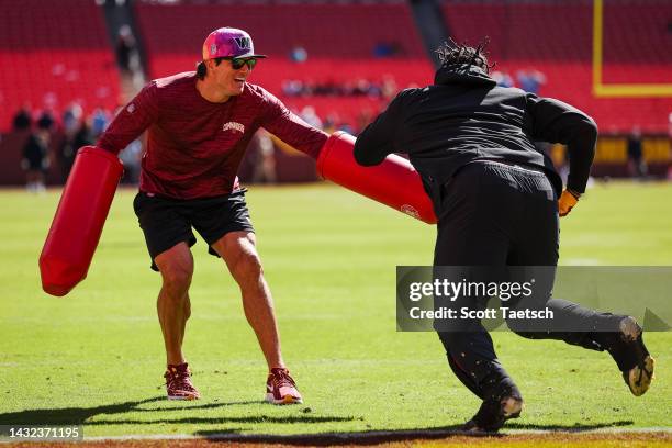 Assistant defensive line and former player Ryan Kerrigan of the Washington Commanders works with Jonathan Allen before the game against the Tennessee...
