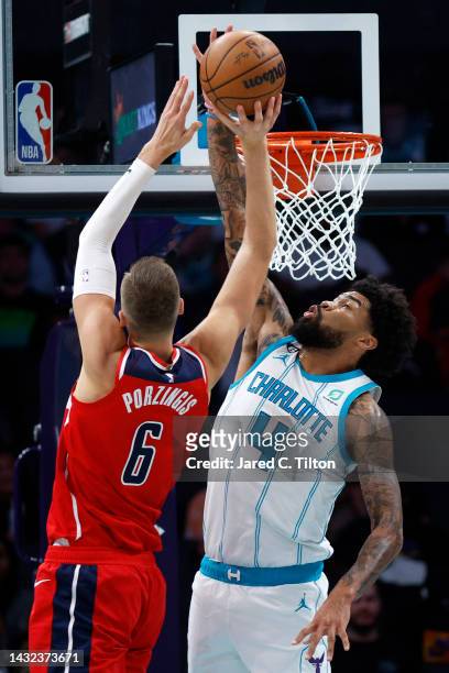 Nick Richards of the Charlotte Hornets blocks a shot attempt from Kristaps Porzingis of the Washington Wizards during the second quarter of the game...