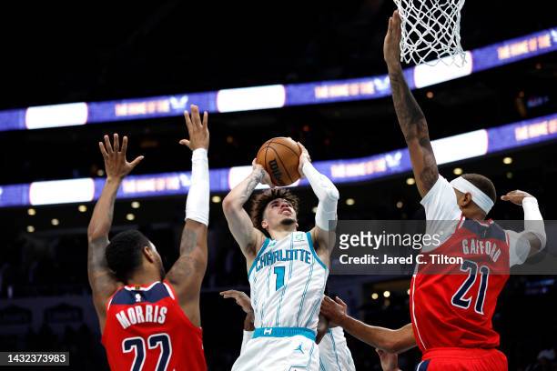 LaMelo Ball of the Charlotte Hornets drives to the basket against Daniel Gafford Monte Morris of the Washington Wizards during the second quarter of...