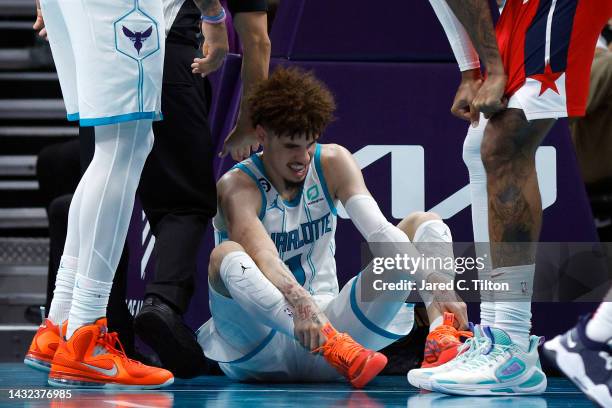 LaMelo Ball of the Charlotte Hornets reacts after he is fouled and injured during the third quarter of the game against the Washington Wizards at...