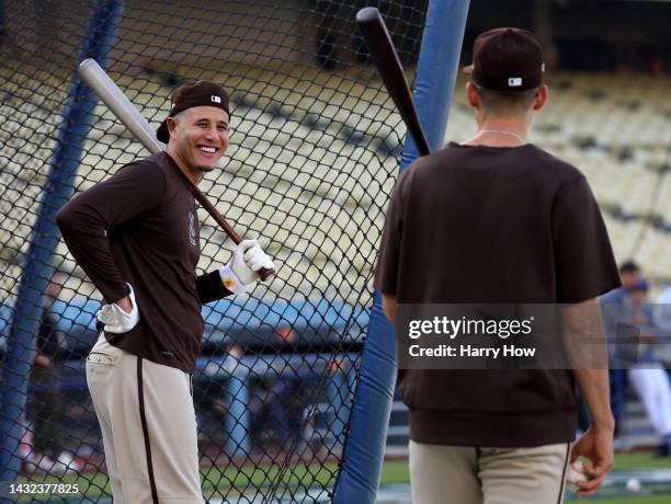 Manny Machado of the San Diego Padres laughs during a workout before the MLB National League Division Series against the Los Angeles Dodgers at...