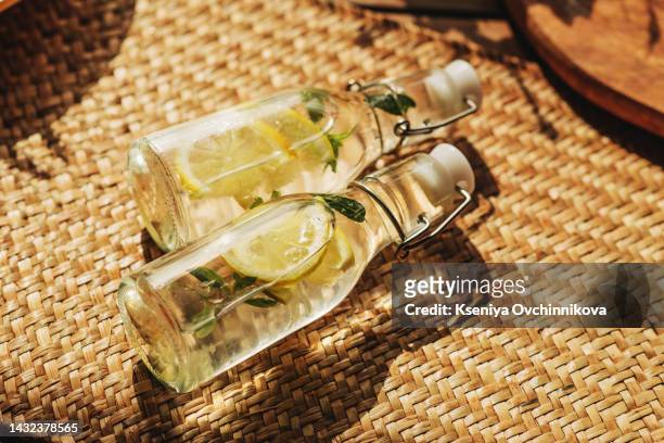 small bottles of lemonade in the sunlight - softdrinks bottle stock-fotos und bilder
