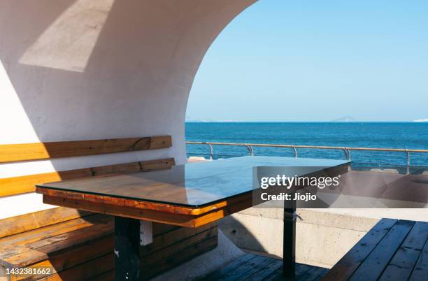 table and chair in seaside park - casual low view desk cafe stock pictures, royalty-free photos & images