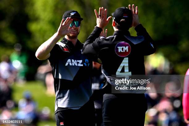 Jimmy Neesham and Michael Bracwell of New Zealand celebrate the wicket of Shan Masood during game four of the T20 International series between New...