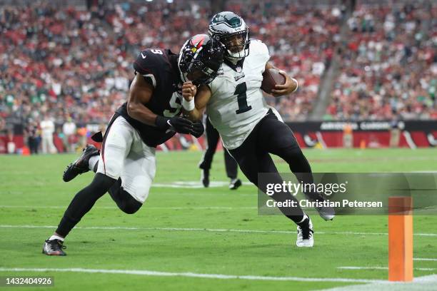 Quarterback Jalen Hurts of the Philadelphia Eagles is knocked out of bounds by linebacker Isaiah Simmons of the Arizona Cardinals during the first...