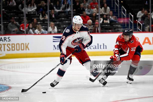 Patrik Laine of the Columbus Blue Jackets handles the puck against Evgeny Kuznetsov of the Washington Capitals during a preseason game at Capital One...