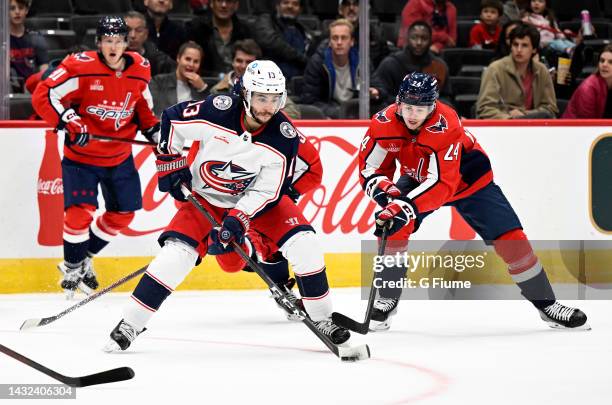 Johnny Gaudreau of the Columbus Blue Jackets handles the puck against Connor McMichael of the Washington Capitals during a preseason game at Capital...