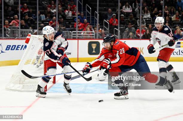 Nick Blankenburg of the Columbus Blue Jackets clears the puck against Connor Brown of the Washington Capitals during a preseason game at Capital One...