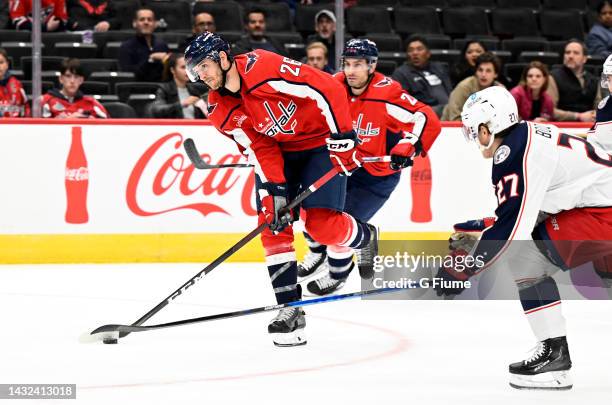 Nic Dowd of the Washington Capitals handles the puck against the Columbus Blue Jackets during a preseason game at Capital One Arena on October 08,...