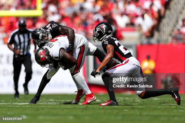 Rashaan Evans of the Atlanta Falcons tackles Leonard Fournette of the Tampa Bay Buccaneers during an NFL football game at Raymond James Stadium on...