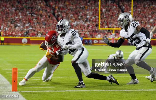 Clyde Edwards-Helaire of the Kansas City Chiefs carries the ball as Rock Ya-Sin of the Las Vegas Raiders defends during the game at Arrowhead Stadium...