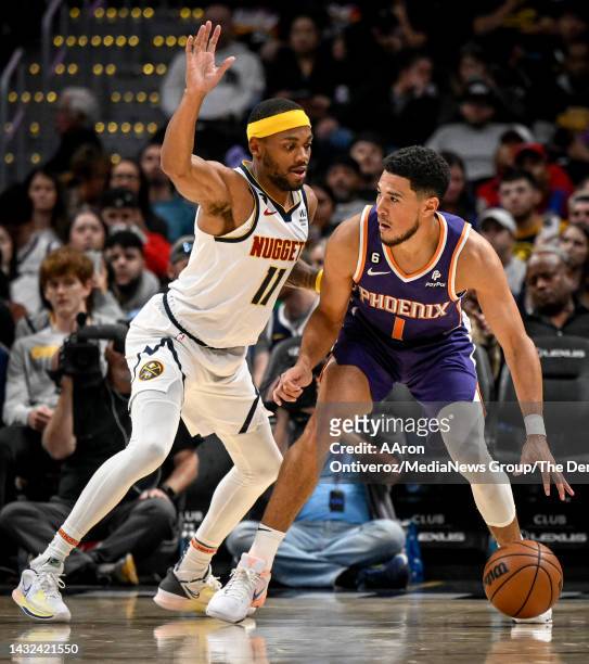 Devin Booker of the Phoenix Suns backs down Bruce Brown of the Denver Nuggets during the third quarter on Monday, October 10, 2022.