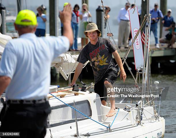 Matt Rutherford, right, pulls his sailboat up to a dock in Annapolis MD, since he departed on a non-stop solo 314 day circumnavigation sailing of the...