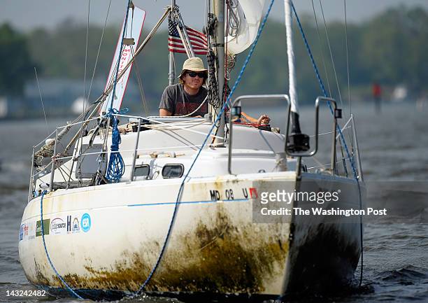 Matt Rutherford, center, in his 27 foot Albin Vega sailboat, sails the last few miles up the Chesapeake Bay completing a non-stop solo 314 day...