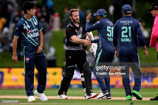 Kane Williamson of New Zealand shakes hands with Babar Azam of Pakistan during game four of the T20 International series between New Zealand and...